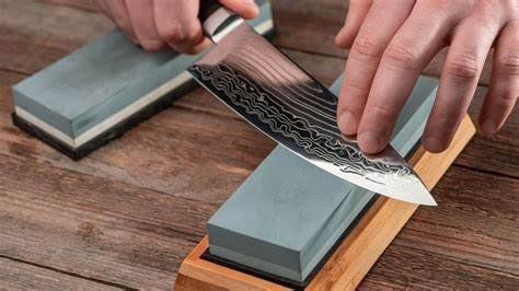 Sharpening a chef's knife on a whet stone