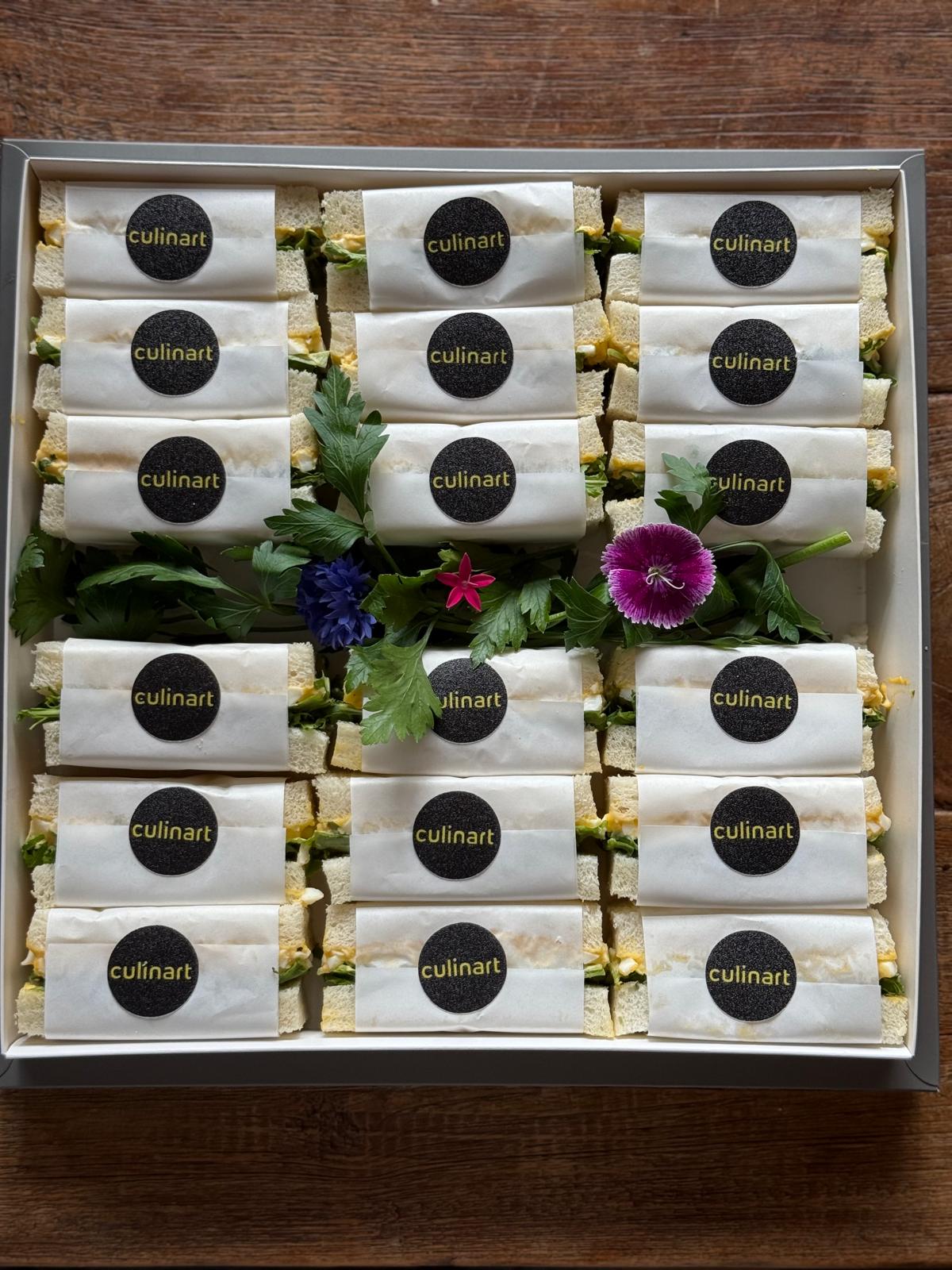 Box of Culinart sandwiches on a wooden surface