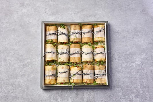 Box of wrapped sandwiches on a gray background