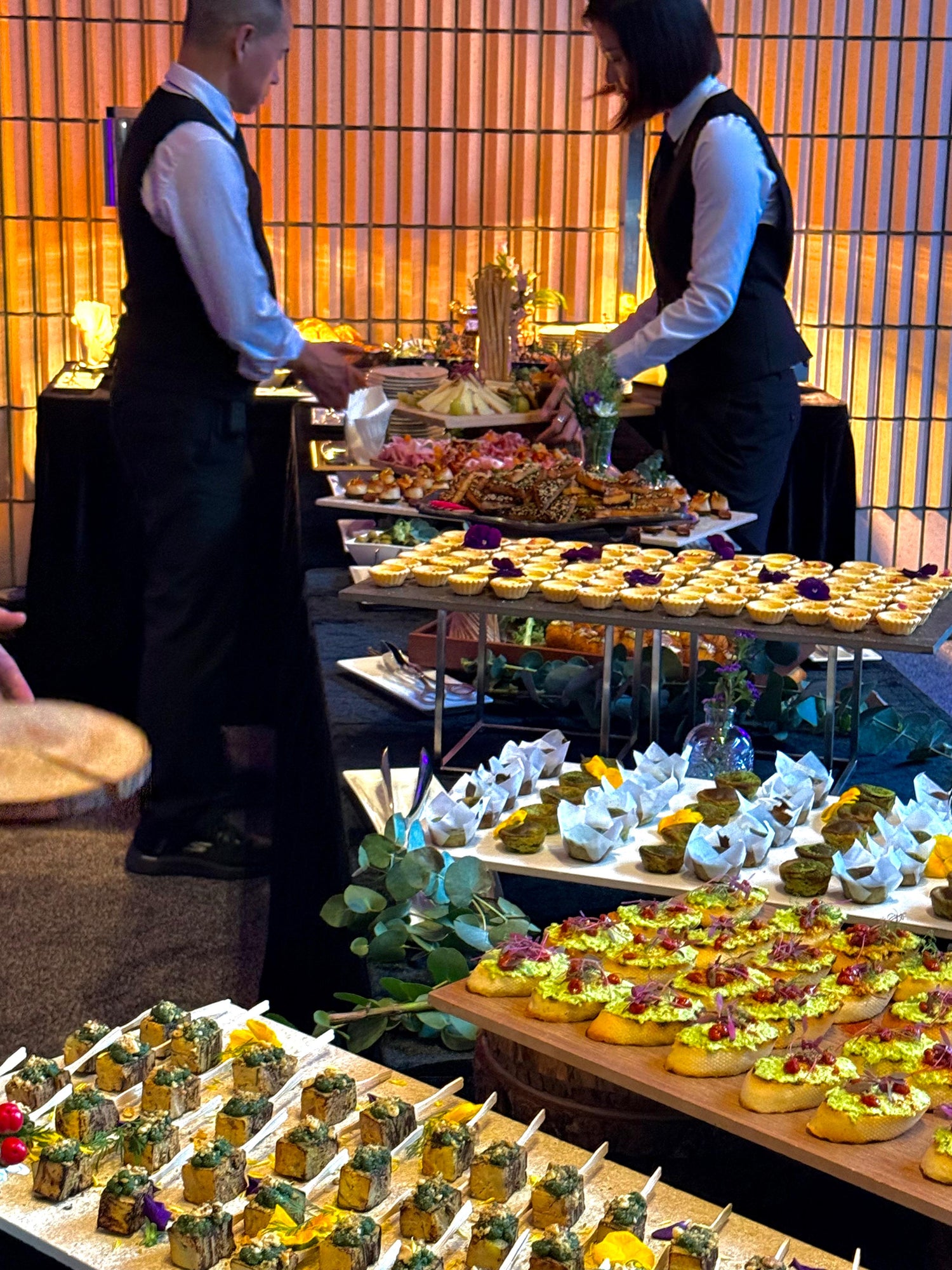 Our friendly staff tending to a canape buffet