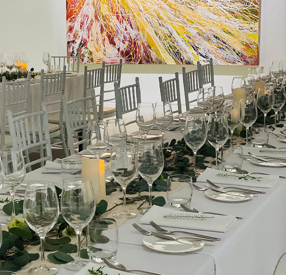 Elegant dinner set-up at a gallery